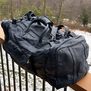 Mexican made navy blue leather carry on, duffle bag. Handles and removable strap